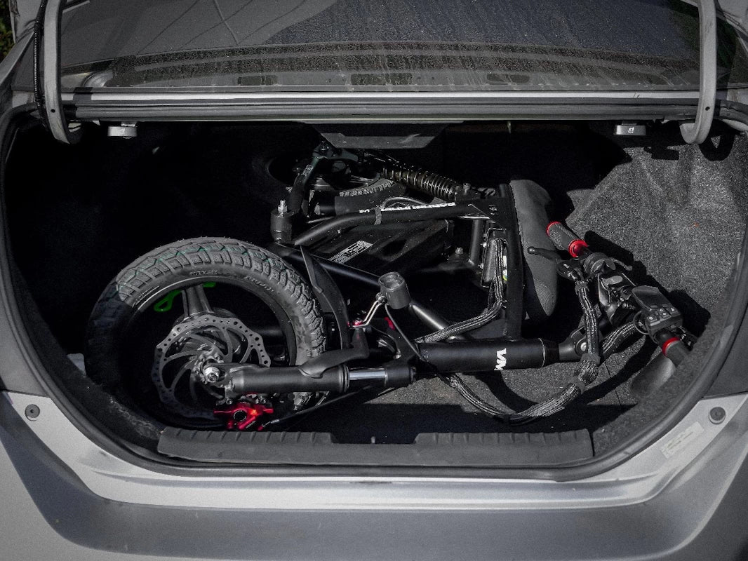 Roadrunner V3 packed into the boot of a coupe, displaying the portability of the RRV3, even without the handlebars folded.