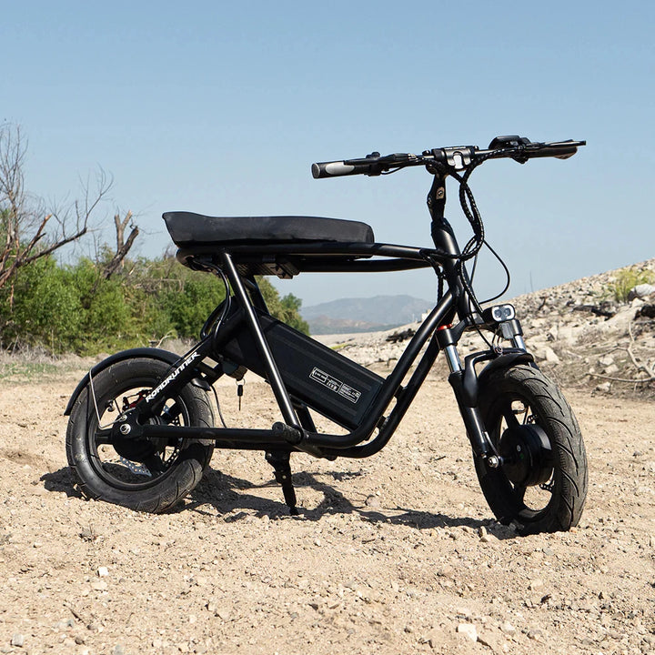 EMOVE Roadrunner v2 seated electric scooter on dirt trail with scenic background - Featuring a rugged design suitable for off-road adventures, highlighting the EMOVE Roadrunner's versatility and lightweight frame.