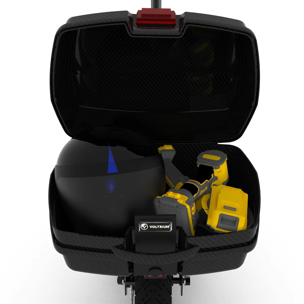 Lockable rear storage box for Voltrium Rogue scooter holding helmet and power tools, demonstrating ample storage capacity.
