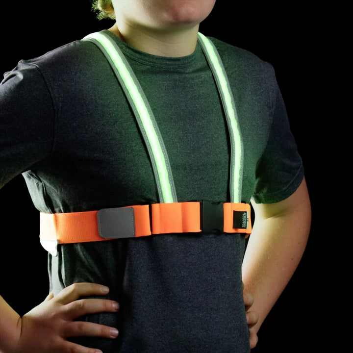 Front view of a child wearing the TracerJR LED Safety Vest with bright green LED lights and an adjustable chest strap.