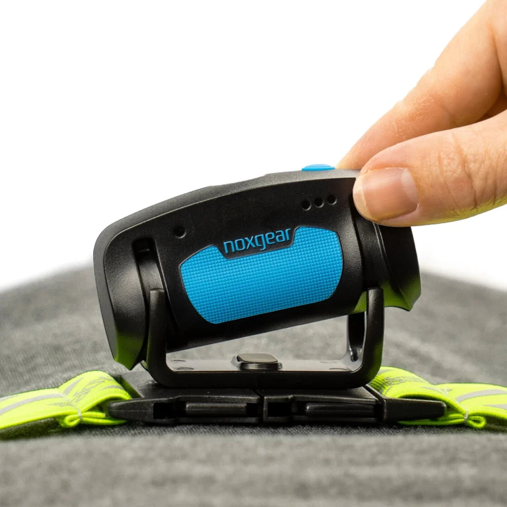 Close-up of Tracer Lamp being installed onto Tracer vest buckle – user setup detail