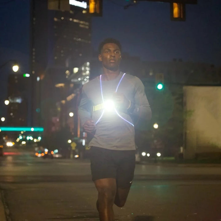 Runner using the NoxGear Tracer Lamp at night for enhanced safety and visibility on city streets
