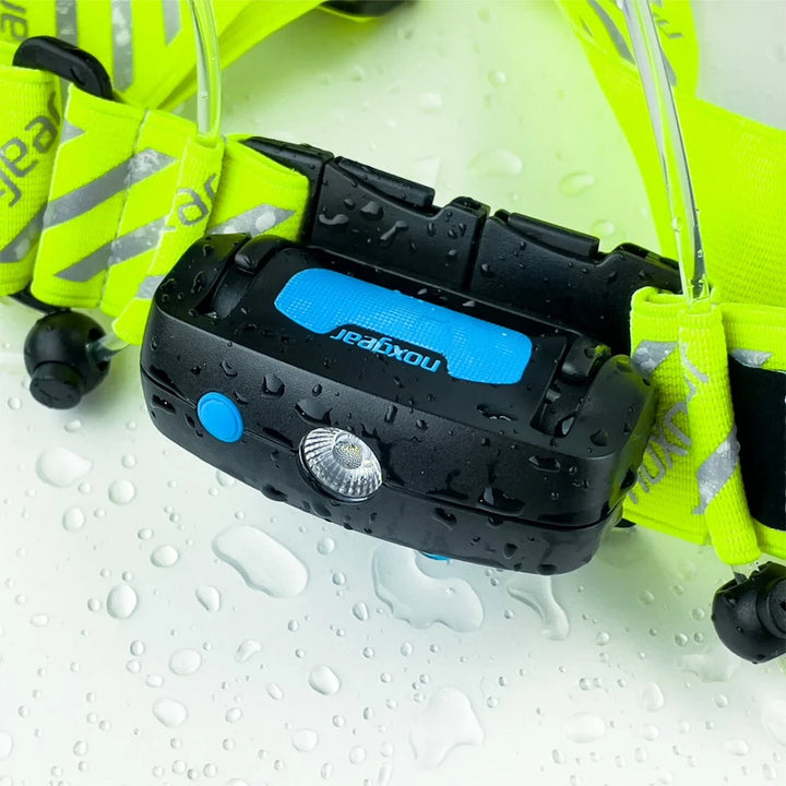 Waterproof NoxGear Tracer Lamp shown with water droplets – IP64-rated light with high-visibility vest