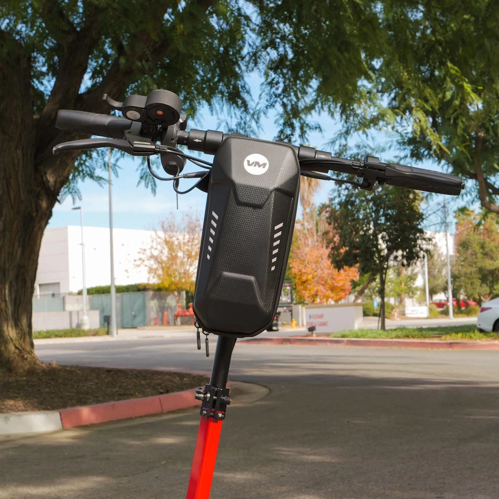 Voro Motors EVA Hard Shell Pouch securely mounted on the handlebar of an EMOVE Cruiser, providing convenient storage for essential items like phone, charger, and gloves.