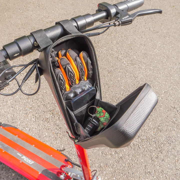 Open EVA pouch mounted on an orange EMOVE Cruiser, highlighting its functional design and practical storage for everyday essentials, such as keys, phone and gloves.