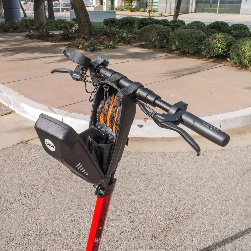 An unzipped EVA pouch mounted on a Cruiser handlebar, providing convenient storage for essential items like phone, charger, and gloves.