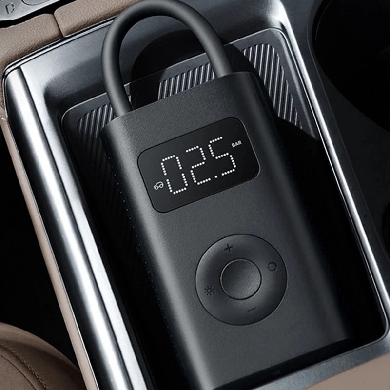 Xiaomi 1S Digital Air Pump with compact design , sitting in a car console.