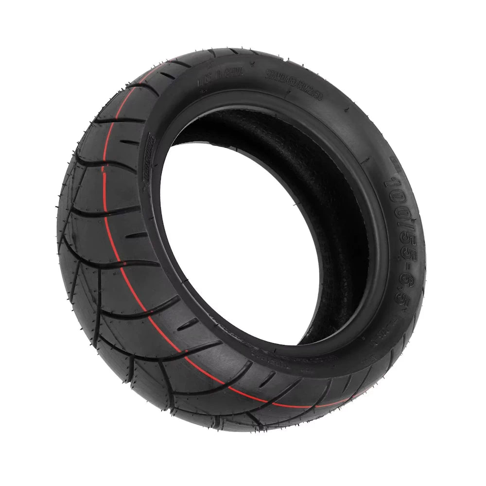 Angled underside view of Xuancheng 11 inch tubeless tyre revealing detailed V-groove tread pattern and tyre wall markings.