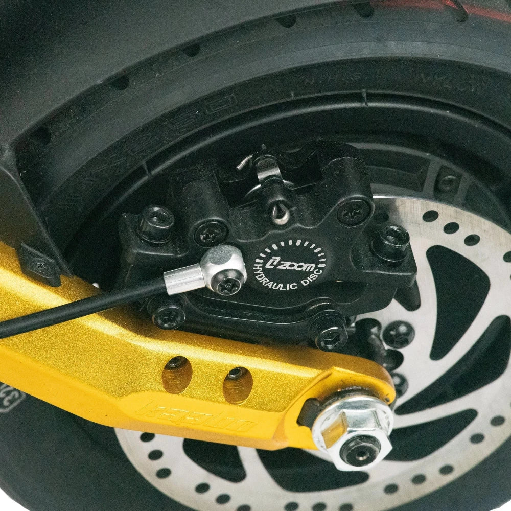 Zoom Hydraulic Brake Calliper fitted to the rear wheel of an electric scooter for enhanced braking power.