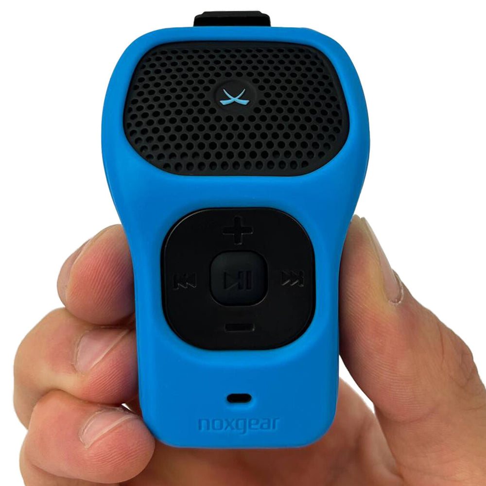 Compact Noxgear 39g wearable Bluetooth speaker with Blue silicone skin shown in hand for size reference.