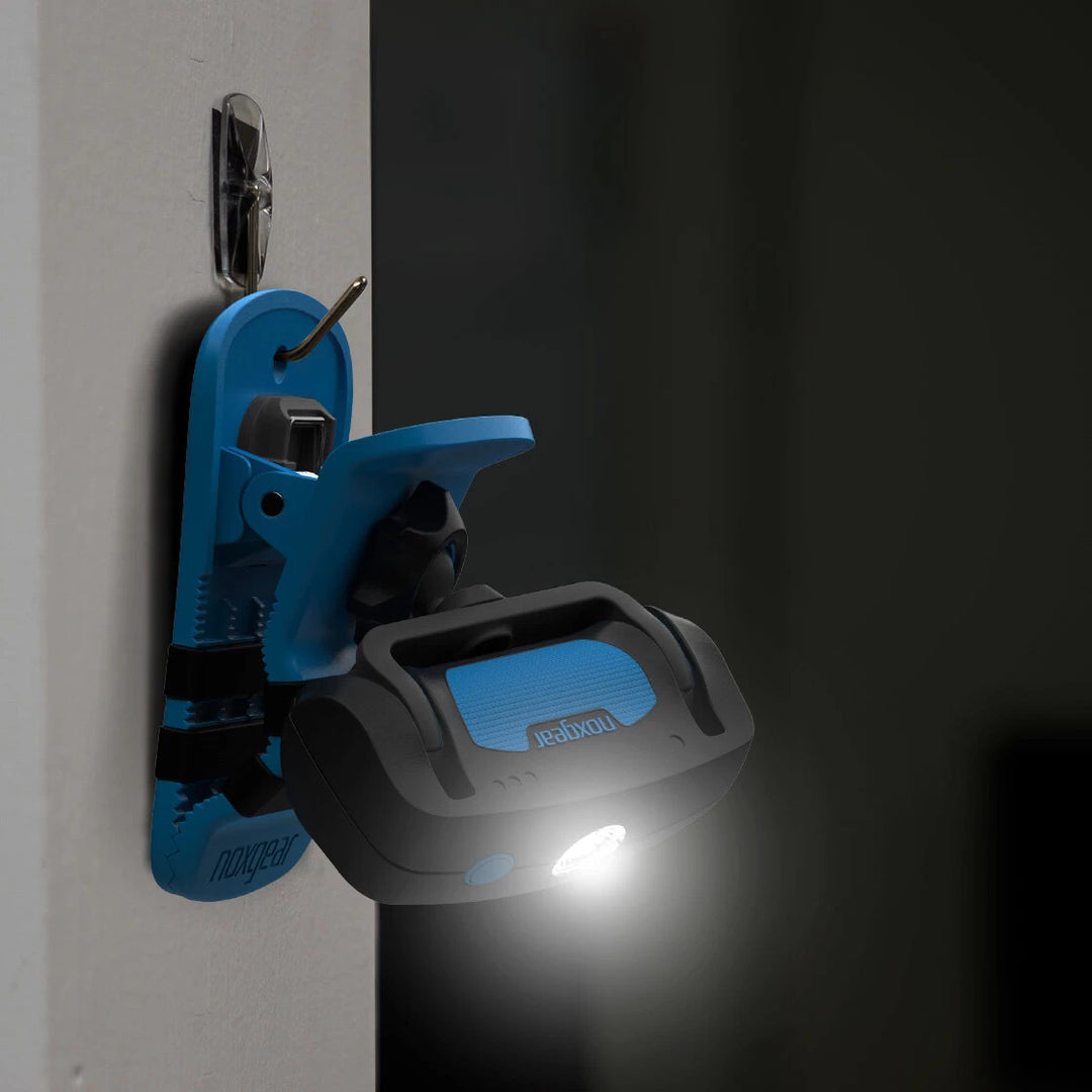 Noxgear Clip Anywhere rechargeable work light hanging from wall hook using rear mounting hole