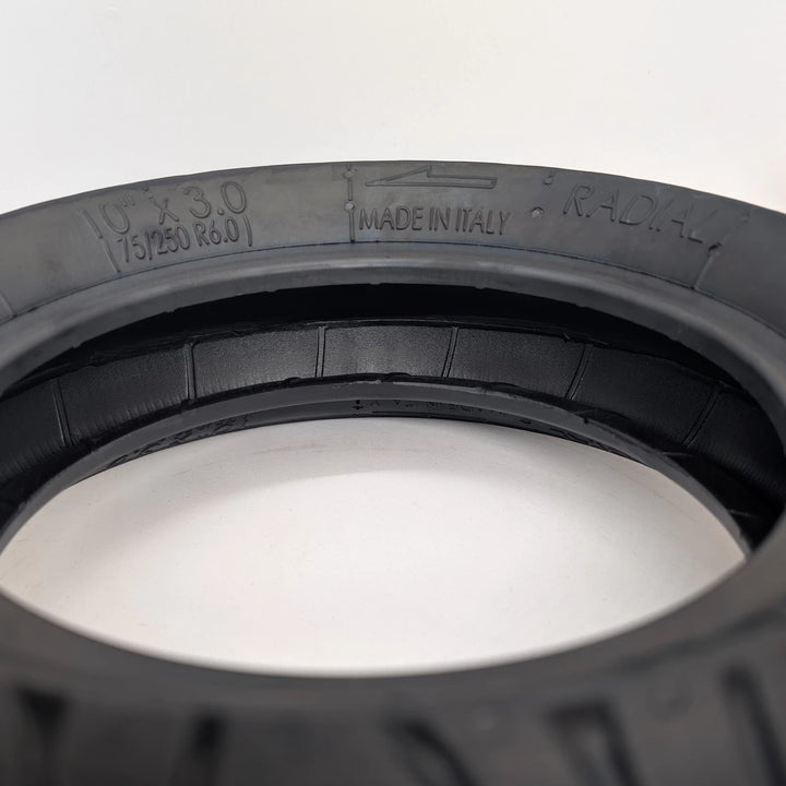 View inside the PMT 10x3.0 (75/250-R6.0) E-Fire Radial Tyre, showing the internal construction, and the sizing, directional fitment arrow and Radial construction, embossed on tyre wall.