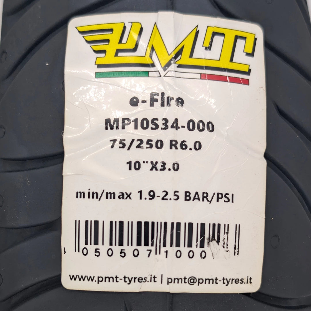 Close-up view of the label and barcode on the PMT 10x3.0 (75/250-R6.0) E-Fire Radial tyre, optimized for 1.8-3 Bar (26-43 PSI) pressure.