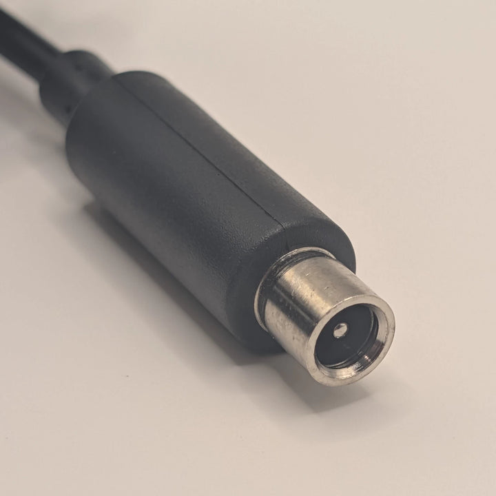 Close-up of the 8mm Xiaomi-style charging plug showing its central contact and metal outer sleeve