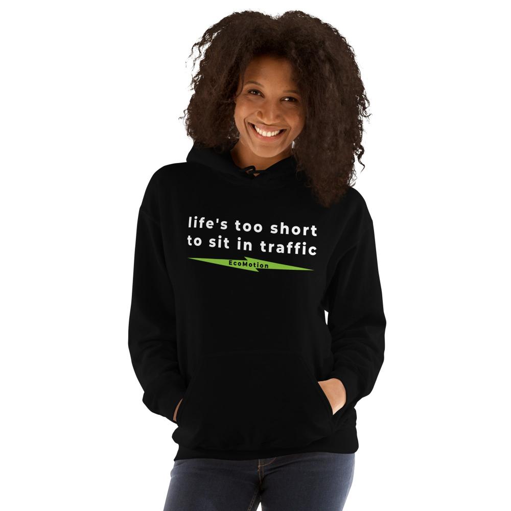 Woman smiling and wearing a black "Life's Too Short To Sit In Traffic" EcoMotion hoodie, promoting electric transportation and casual wear and a main benefit of commuting by electric scooter.