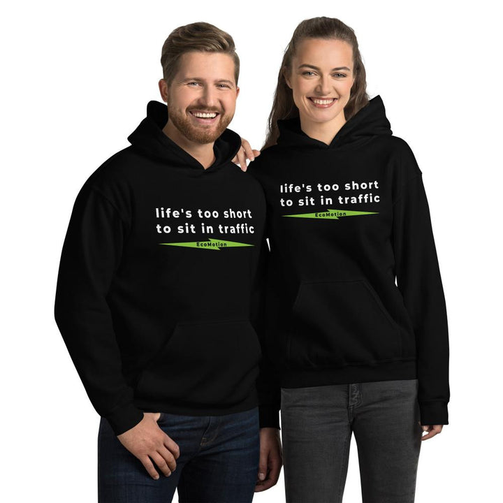 Happy couple in matching "Life's Too Short To Sit In Traffic" EcoMotion hoodies in black, ideal for promoting electric mobility and sustainable fashion.