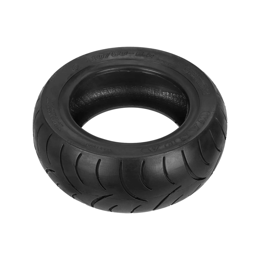 Wanda tubeless tyre lying flat, showing tread grooves, sidewall branding and 110/50-6.5 size marking