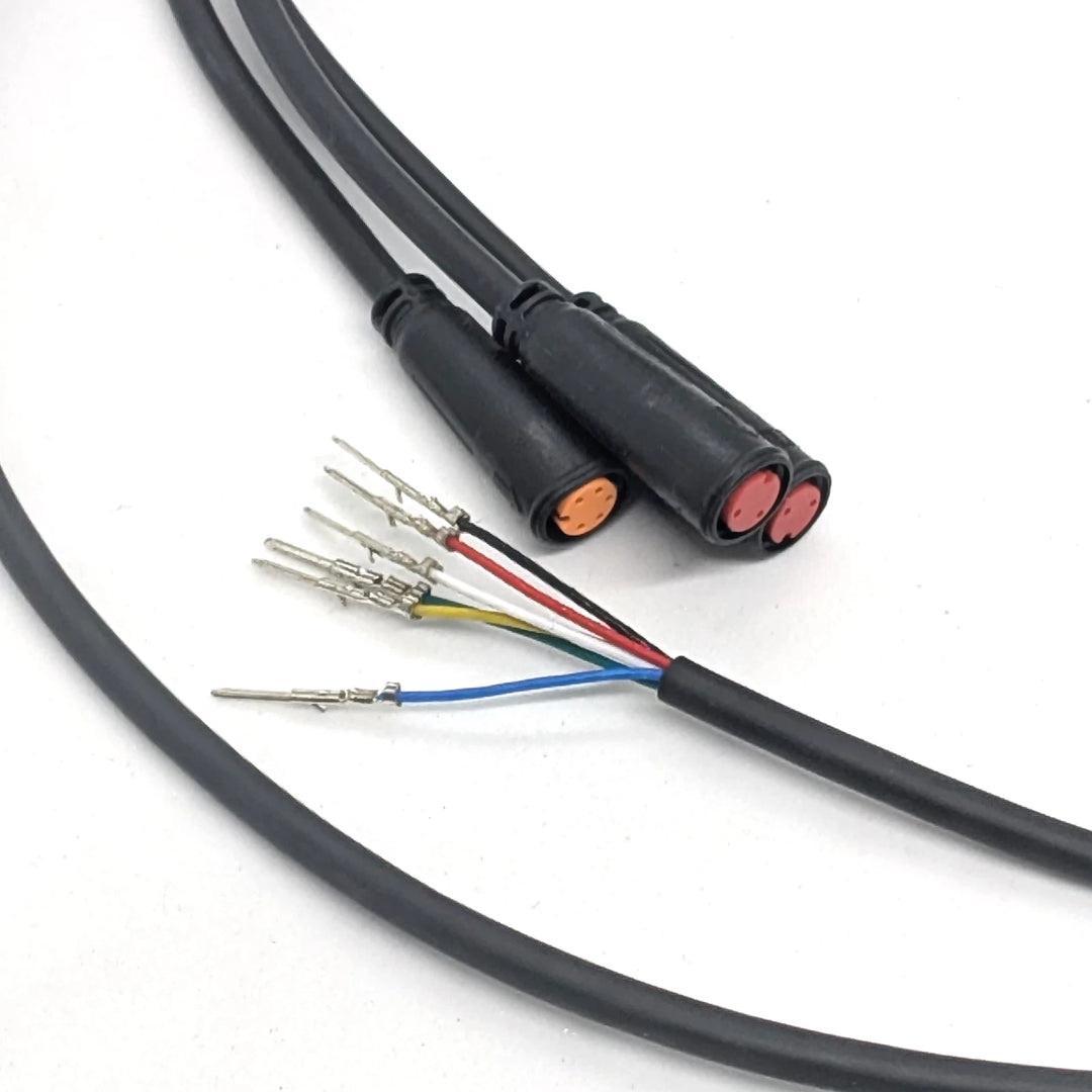 Close-up of the orange 5-pin and dual red 2-pin waterproof Julet connectors on the OEM main connector cable.