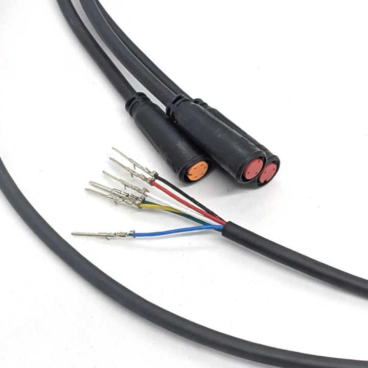 Close-up of the orange 5-pin and dual red 2-pin waterproof Julet connectors on the OEM main connector cable.