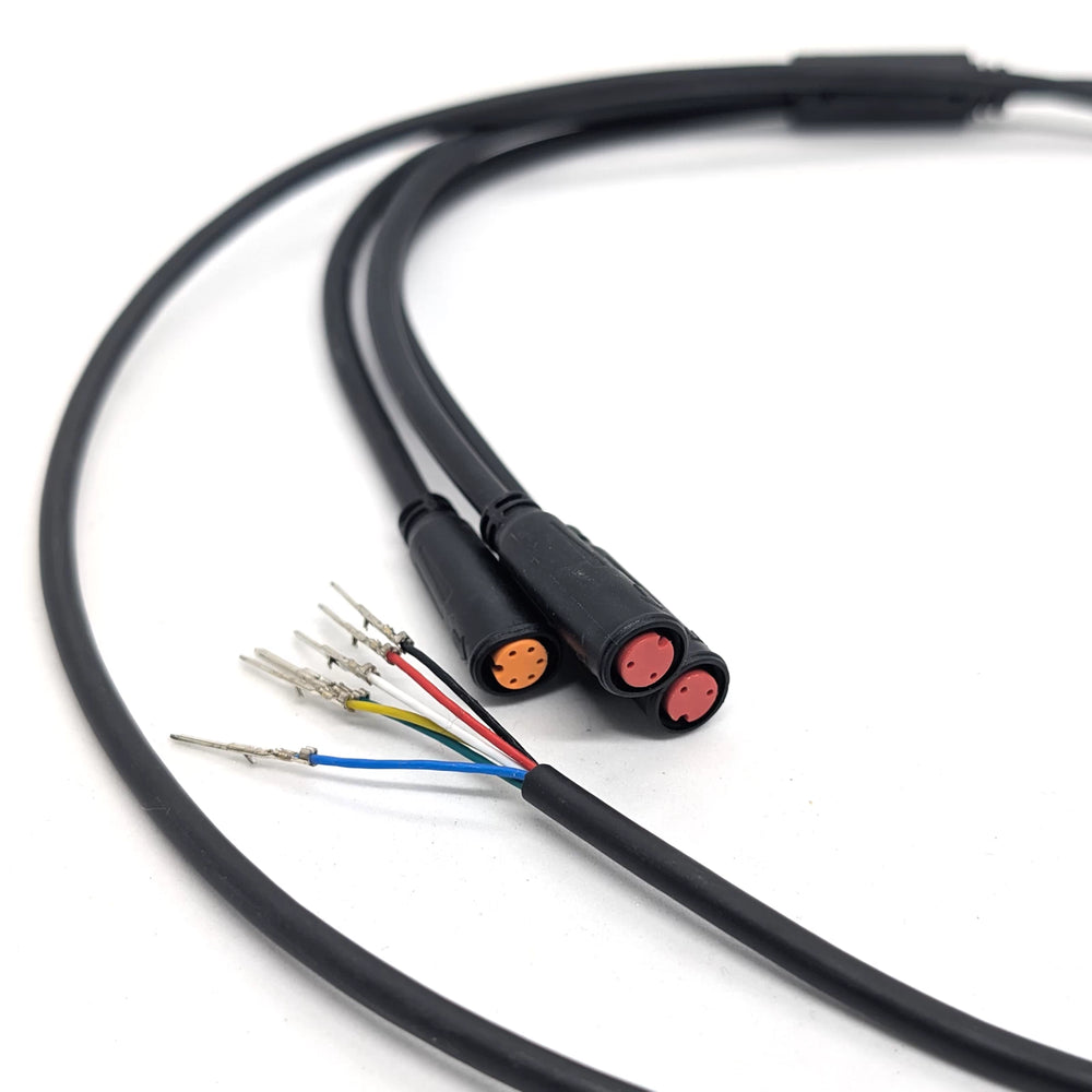 Close-up of the orange 5-pin and dual red 2-pin waterproof Julet connectors on the OEM main connector cable.