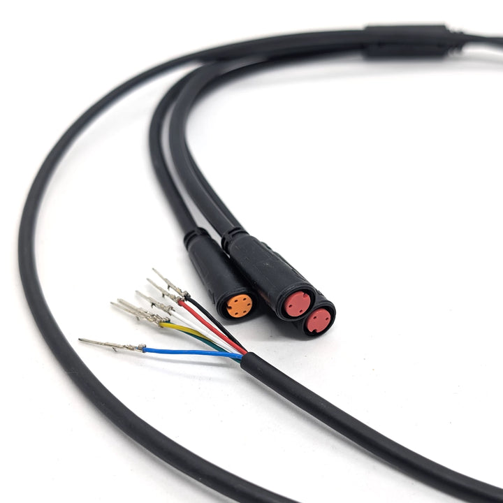 Close-up of the orange 5-pin and dual red 2-pin waterproof Julet connectors on the OEM main connector cable.