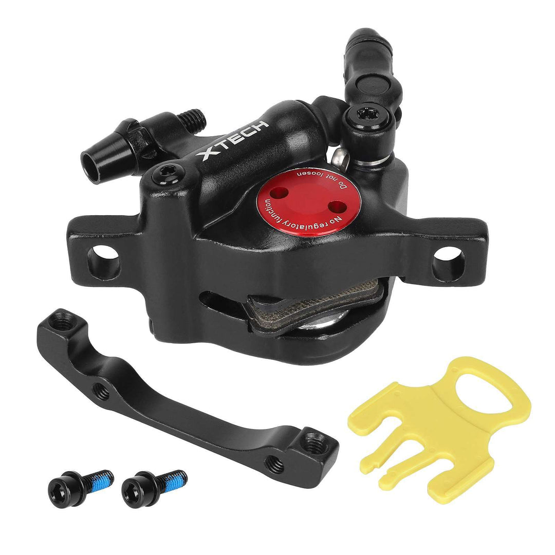 Underside view of Xtech Zoom HB100 black hydraulic brake calliper, showing pre-fitted brake pads and mounting hardware.