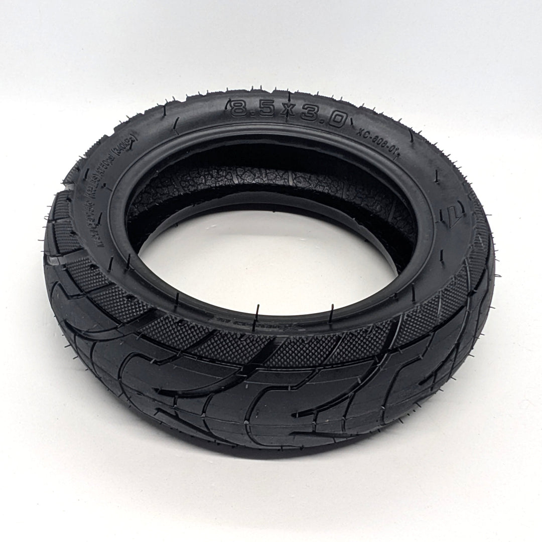 Angled view of Xuancheng 8.5x3.0 OEM tubeless electric scooter tyre with directional road tread.