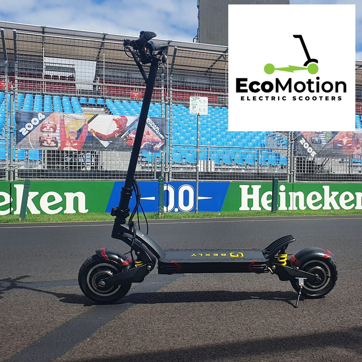 Side profile of a Bexly 10X electric scooter parked on the Formula 1 straight at Albert Park, Melbourne, in front of the empty stands. A banner of F1 champion Michael Schumacher from 2004 is visible on the safety fence. The powerful scooter is showcased on the iconic F1 track, emphasizing its performance and urban mobility capabilities.